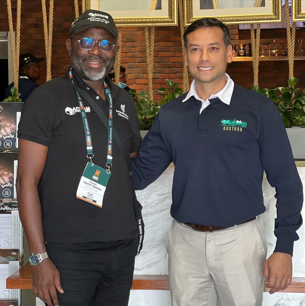 Executive Secretary Ismaël NDJEWE NDOMBA of ACRAM with Colin James Francis, CEO of Gostoso Coffee, discussing sustainable coffee initiatives.